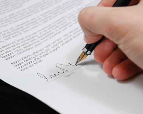 person signing a document